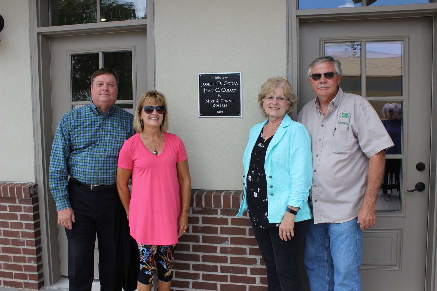 A special plaque was unveiled during the Mansfield Depot dedication ceremony paying tribute to Joseph D. Coday and Jean C. Coday from Connie and Mike Rogers, on the right. Also pictured are Joe and Kelley Coday.